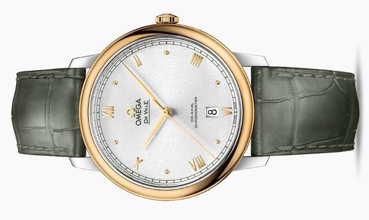 The 18k gold bezel fake watch has a green strap.